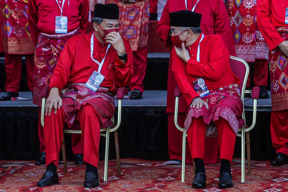 Umno president Datuk Seri Ahmad Zahid Hamidi (right) speaks to deputy president Datuk Seri Mohamad Hasan at the World Trade Centre Kuala Lumpur March 28, 2021. u00e2u20acu201d Picture by Hari Anggara