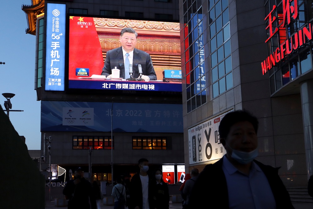 A giant screen shows news footage of Chinese President Xi Jinping attending a video summit on climate change with German Chancellor Angela Merkel and French President Emmanuel Macron, at a shopping street in Beijing April 16, 2021. u00e2u20acu201d Reuters pic