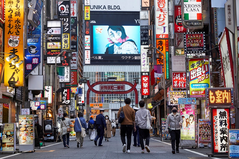 Passersby wearing protective masks stroll through Kabukicho entertainment district during the Covid-19 pandemic in Tokyo April 6, 2021. u00e2u20acu201d Reuters pic