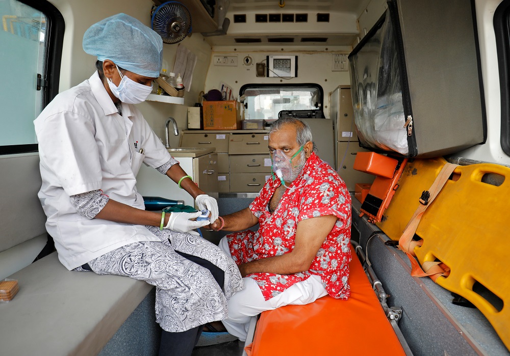 A paramedic uses an oximeter to check the oxygen level of a patient inside an ambulance while waiting to enter a Covid-19 hospital for treatment in Ahmedabad April 22, 2021. u00e2u20acu201d Reuters pic