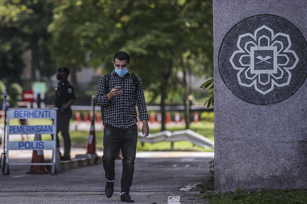 A man exits the International Islamic University Malaysia campus compound in Gombak April 1, 2021. u00e2u20acu201d Picture by Hari Anggara