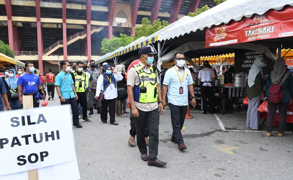 Pengarah Pembersihan dan Kesihatan Persekitaran Majlis Bandaraya Seremban (MBS) , Mohd Loftee Abdullah (kanan) bersama Ketua Polis Balai Rahang Sarjan Mejar (SM) Abdul Rahman Wasis (kiri) meninjau Bazar Ramadan Stadium Paroi 16 April 2021. u00e2u20acu201d Foto Bernam