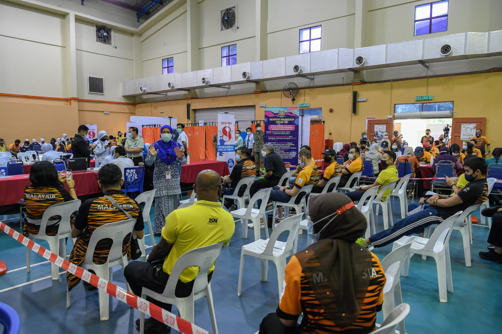 Athletes wait to get their Pfizer-BioNTech vaccinations  at the DBKL sports hall in Kuala Lumpur, April 13, 2021. u00e2u20acu201d Bernama pic 