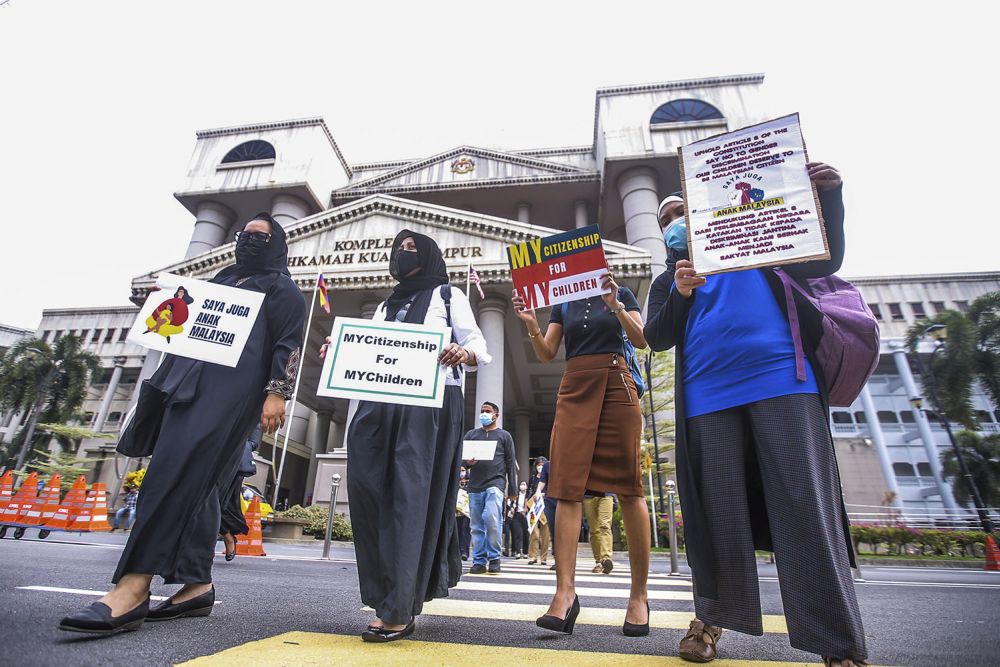 Members of Family Frontiers hold up placards demanding equal citizenship rights for Malaysians at the Kuala Lumpur High Court April 27, 2021. u00e2u20acu201d Picture by Hari Anggara