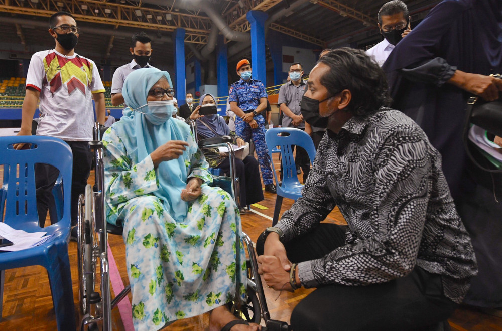 Khairy Jamaluddin speaks to a vaccine recipient during his visit to the vaccine dispensing centre at the Sultan Abdul Halim Stadium, in Kedah, April 26, 2021. u00e2u20acu201d Bernama pic 