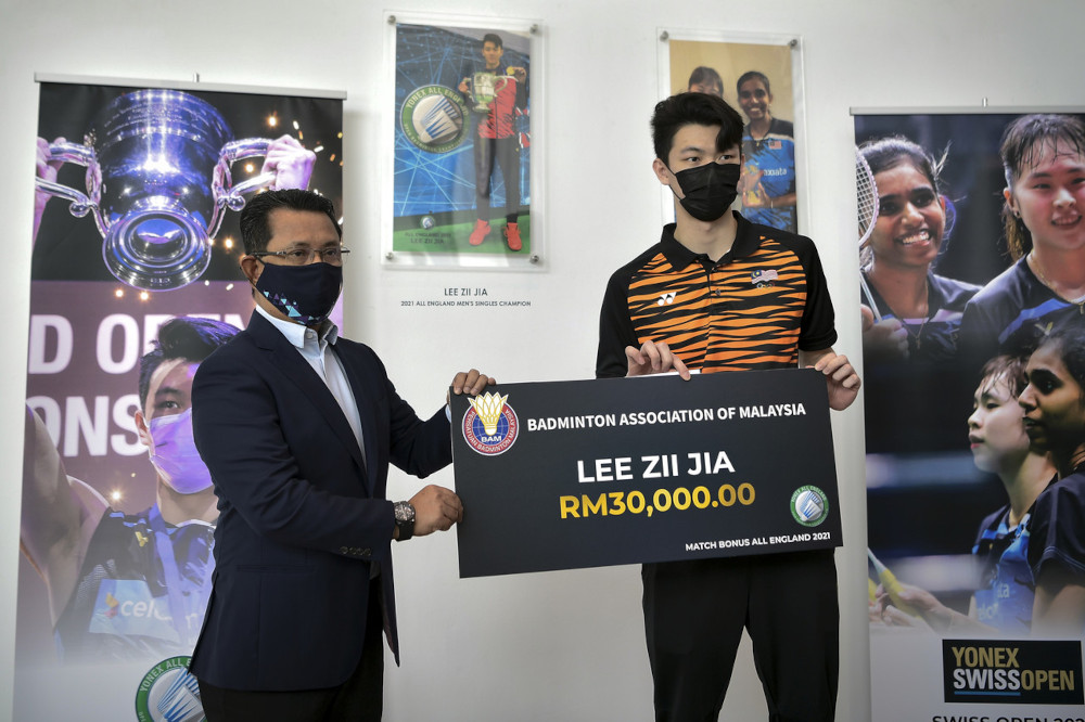 BAM president Tan Sri Mohamad Norza Zakaria hands over a mock cheque to Lee Zii Jia at Academy Badminton Malaysia (ABM) in Bukit Kiara, April 1, 2021. u00e2u20acu201d Bernama pic  