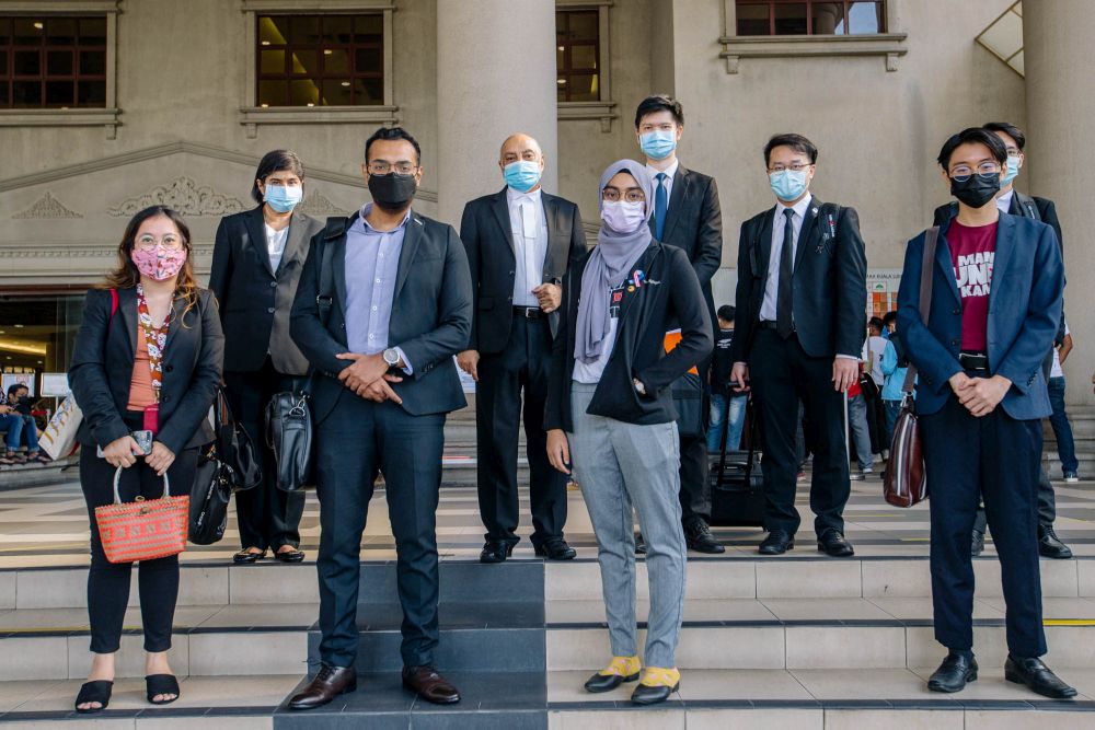 Malaysian youths who filed a lawsuit to push for their right to vote by July 2021 are seen with their lawyers at the Kuala Lumpur Court Complex April 19, 2021. u00e2u20acu201d Picture by Firdaus Latif