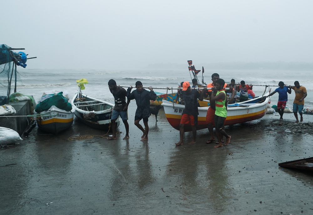 Fishermen carry a boat after receiving a warning about the arrival of Cyclone Tauktae in Mumbai May 17, 2021. u00e2u20acu201d Reuters pic