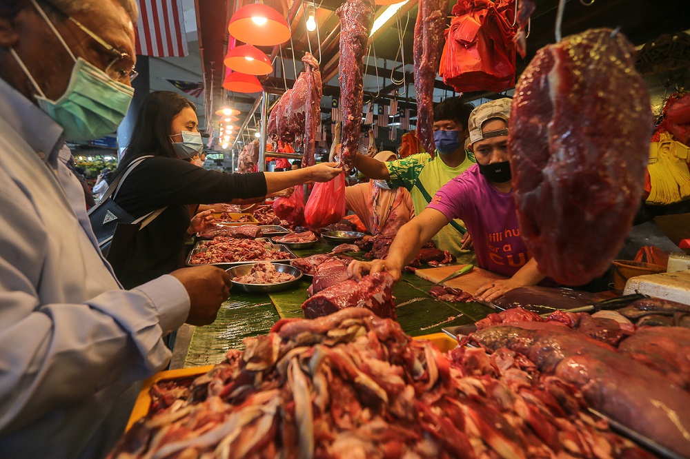 Customers buy fresh meat from a butcher stall at the Seksyen 6 wet market in Shah Alam May 11, 2021. u00e2u20acu201d Picture by Yusof Mat Isa