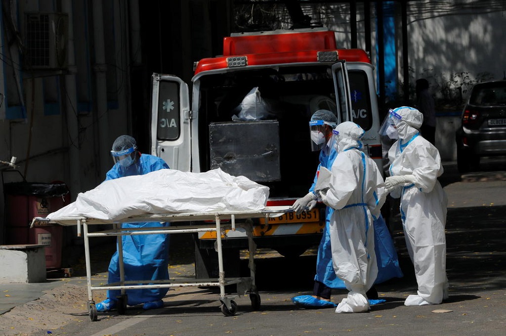 Mortuary workers load the body of a person who died from Covid-19 to an ambulance for cremation, at a hospital in New Delhi May 5, 2021. u00e2u20acu201d Reuters pic