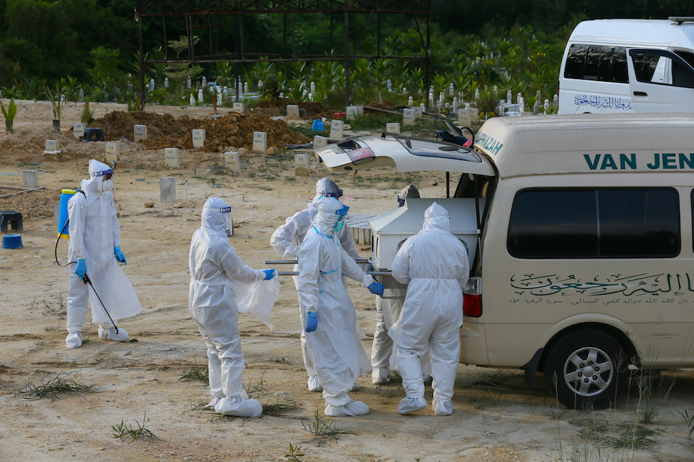 Covid 19 victims body arrive for funeral service handled by health workers equipped with personal protective suit at Kampung Sungai Pusu muslim cemetery May 22,2021.nu00e2u20acu201d Picture by Ahmad Zamzahurinnn