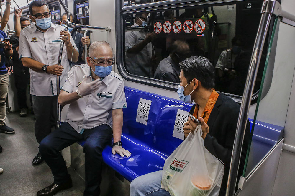 Transport Minister Datuk Seri Wee Ka Siong speaks to a passenger during a visit to the crisis centre at the KLCC Light Rail Transit (LRT) station in Kuala Lumpur May 28, 2021. u00e2u20acu201d Picture by Hari Anggara