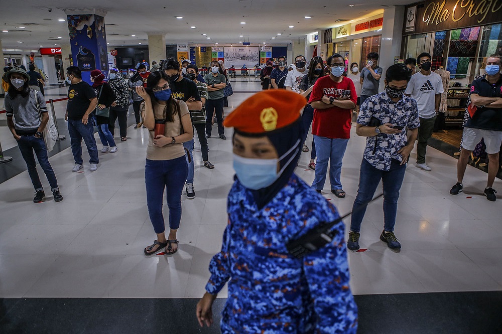 People wait in line to receive their AstraZeneca Covid-19 vaccine shot at the Vaccine Delivery Centre located at Kuala Lumpur World Trade Centre May 29, 2021. u00e2u20acu201d Picture by Hari Anggara