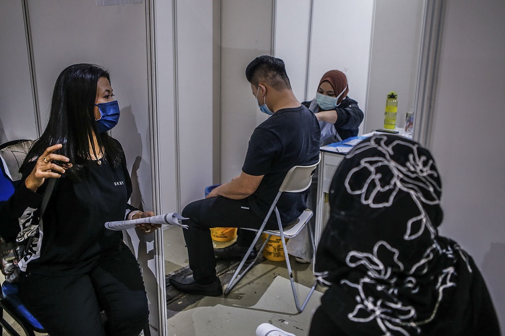 A man receives a AstraZeneca Covid-19 vaccine shot at the Vaccine Delivery Centre located at Kuala Lumpur World Trade Centre May 29, 2021. u00e2u20acu201d Picture by Hari Anggara