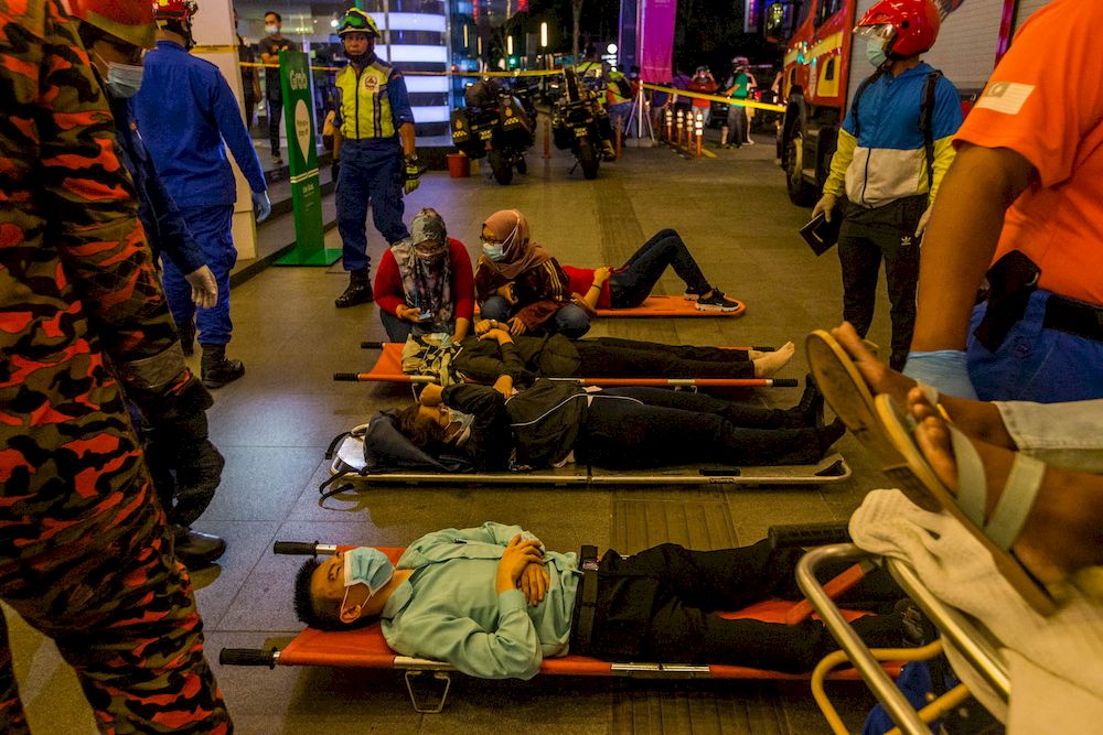 Rescue personnel tending to the injured passengers at KLCC station, after a collision between two LRT trains on the Kelana Jaya line, May 24, 2021. u00e2u20acu201d Picture by Firdaus Latif