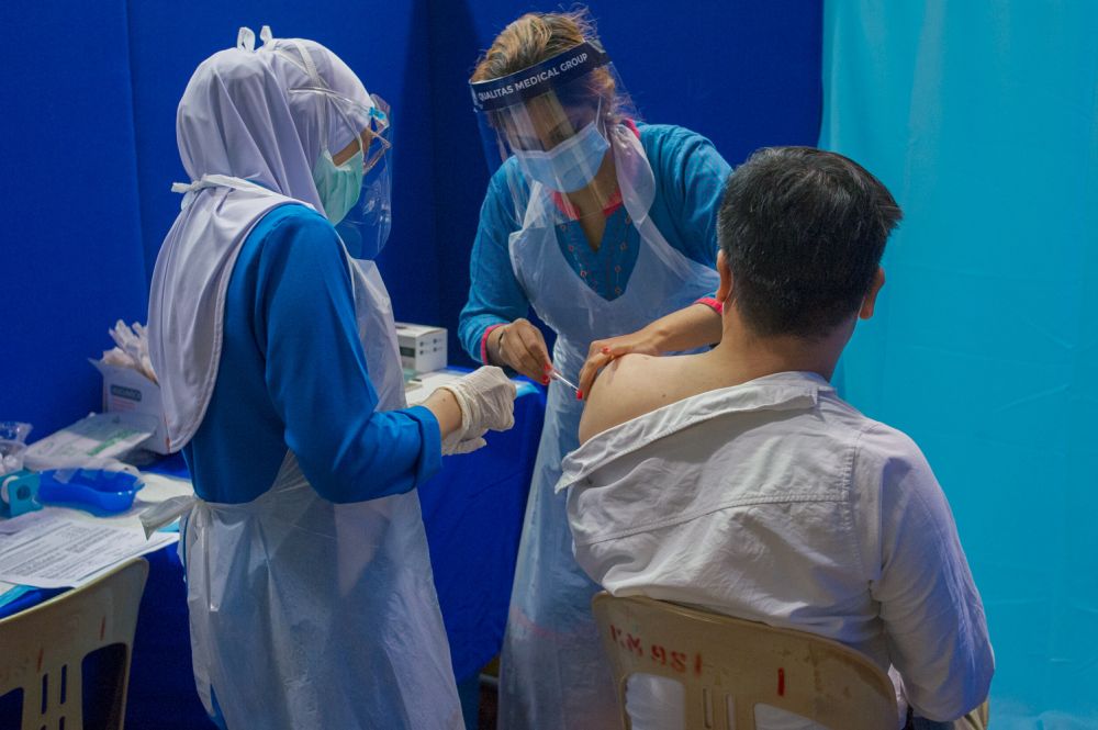 A nurse administers a dose of the AstraZeneca Covid-19 vaccine at the Dewan Gemilang UKM vaccination centre in Bangi May 5, 2021. u00e2u20acu201d Picture by Shafwan Zaidon
