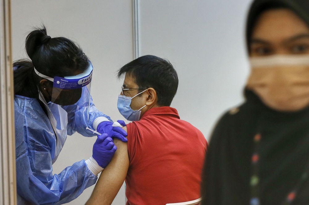 A man receives the AstraZeneca Covid-19 vaccine at the World Trade Centre Kuala Lumpur May 5, 2021. u00e2u20acu2022 Picture by Ahmad Zamzahuri