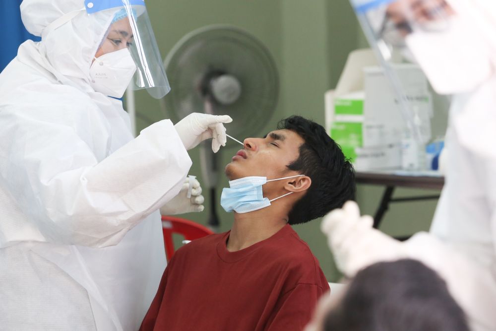 A health worker collects swab samples to test for Covid-19 at the MBPJ community hall in Taman Medan, Petaling Jaya May 24, 2021. u00e2u20acu201d Picture by Choo Choy May