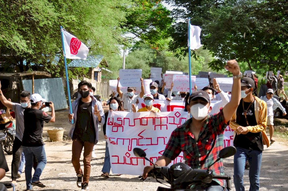 This photo taken and received from an anonymous source via Facebook on May 22, 2021 shows protesters holding banners as they march during a demonstration against the military coup in Mandalay. u00e2u20acu201d Handout / Facebook / AFP pic