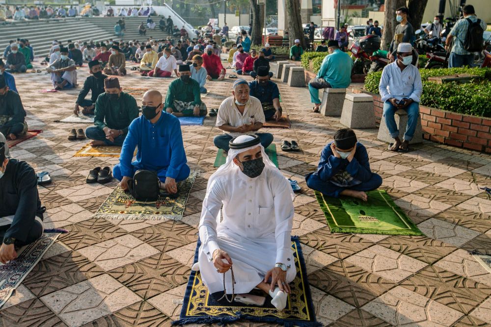 Muslims perform Eid Al-Fitr prayers outside the National Mosque in Kuala Lumpur May 13, 2021. u00e2u20acu201d Picture by Firdaus Latif