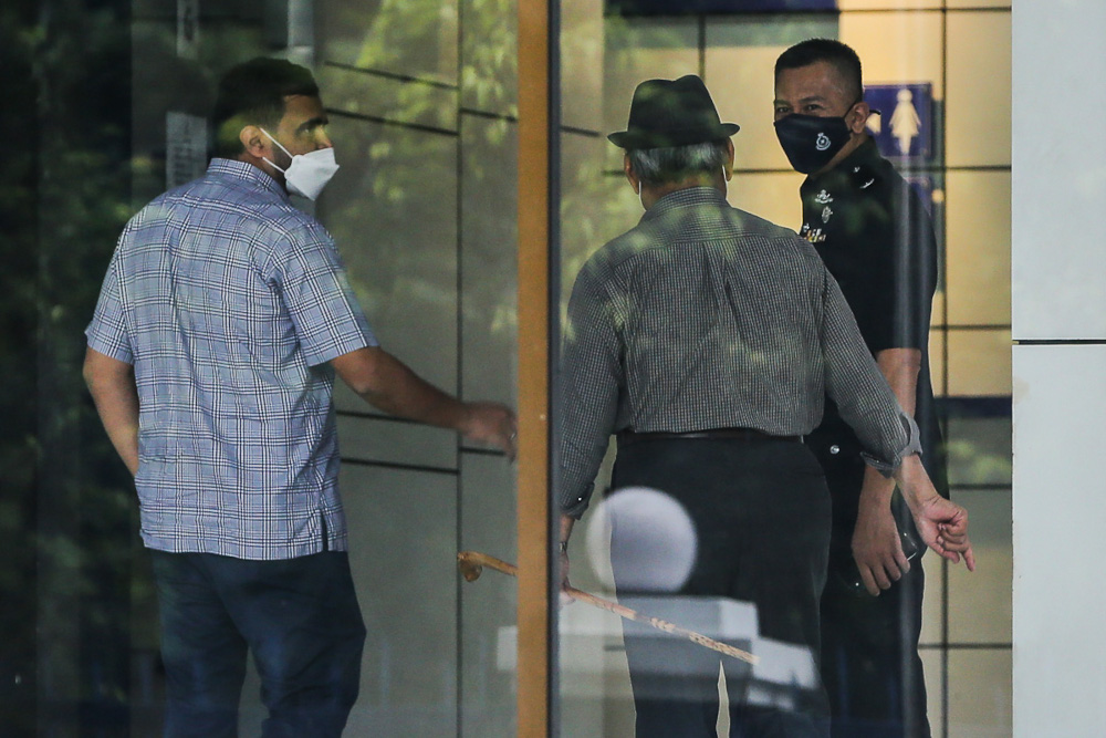 Datuk Seri Tajuddin Abdul Rahman (centre) arriving at the Dang Wangi district police headquarters in Kuala Lumpur May 27, 2021. u00e2u20acu201d Picture by Yusof Mat Isa