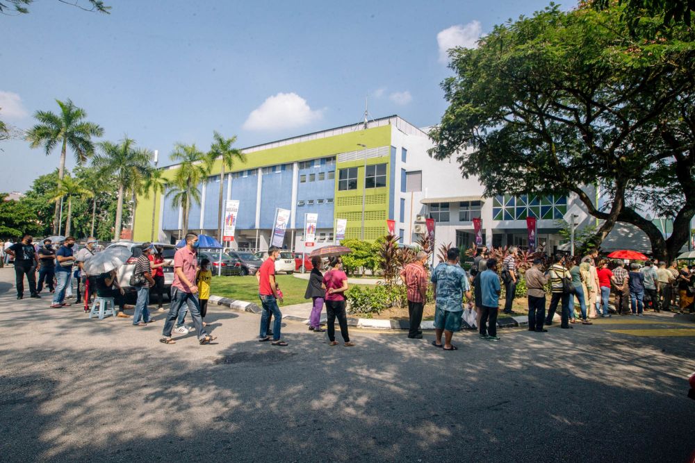People queuing up to receive the Covid-19 vaccine at Stadium Titiwangsa Kuala Lumpur May 25, 2021. u00e2u20acu2022 Picture by Firdaus Latif