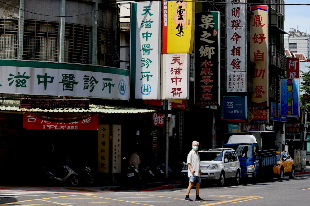 A man crosses the street while wearing a protective mask following the recent rise in Covid-19 infections in Taipei, Taiwan June 2, 2021. u00e2u20acu201d Reuters pic