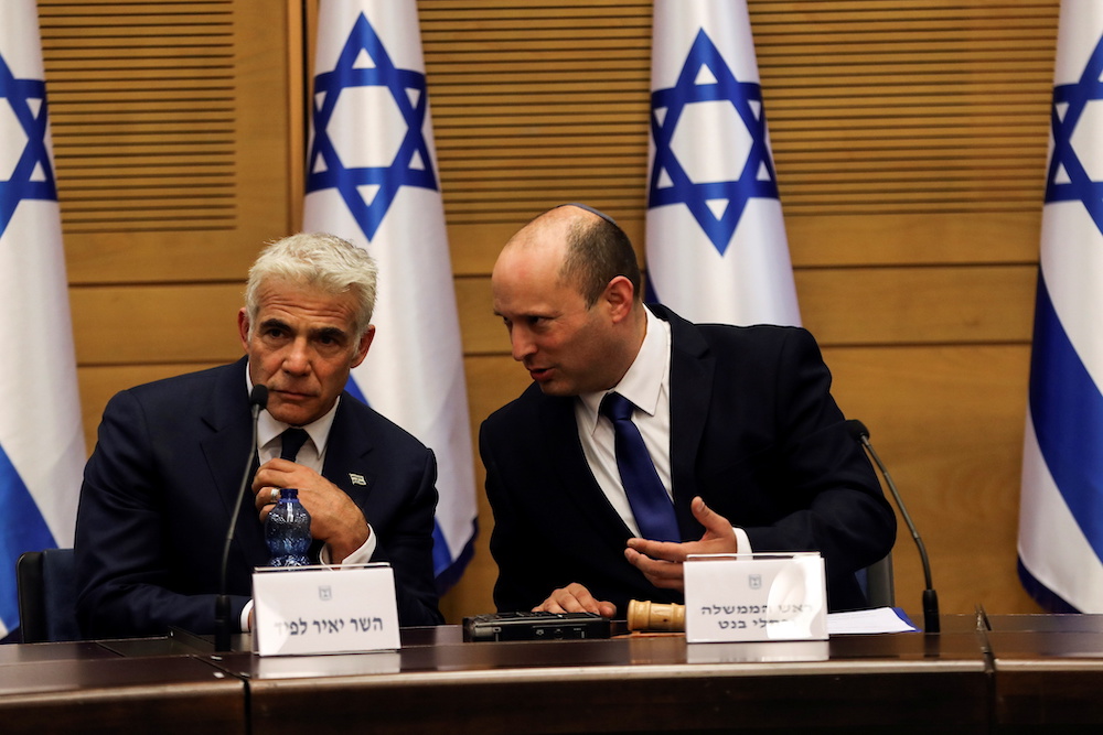 Israeli Prime Minister Naftali Bennett (right) and Foreign Minister Yair Lapid attend its first Cabinet meetiing in the Knesset, Israel's parliament, in Jerusalem June 13, 2021. u00e2u20acu201d Reuters pic