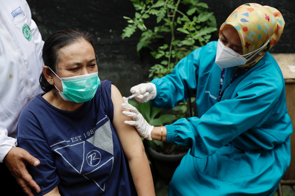 A local woman of Sindanglaya village receives her first dose of China's Sinovac Biotech vaccine for the coronavirus disease outside her house, during a door-to-door vaccination in Cianjur regency, West Java province June 15, 2021. u00e2u20acu201d Reuters pic