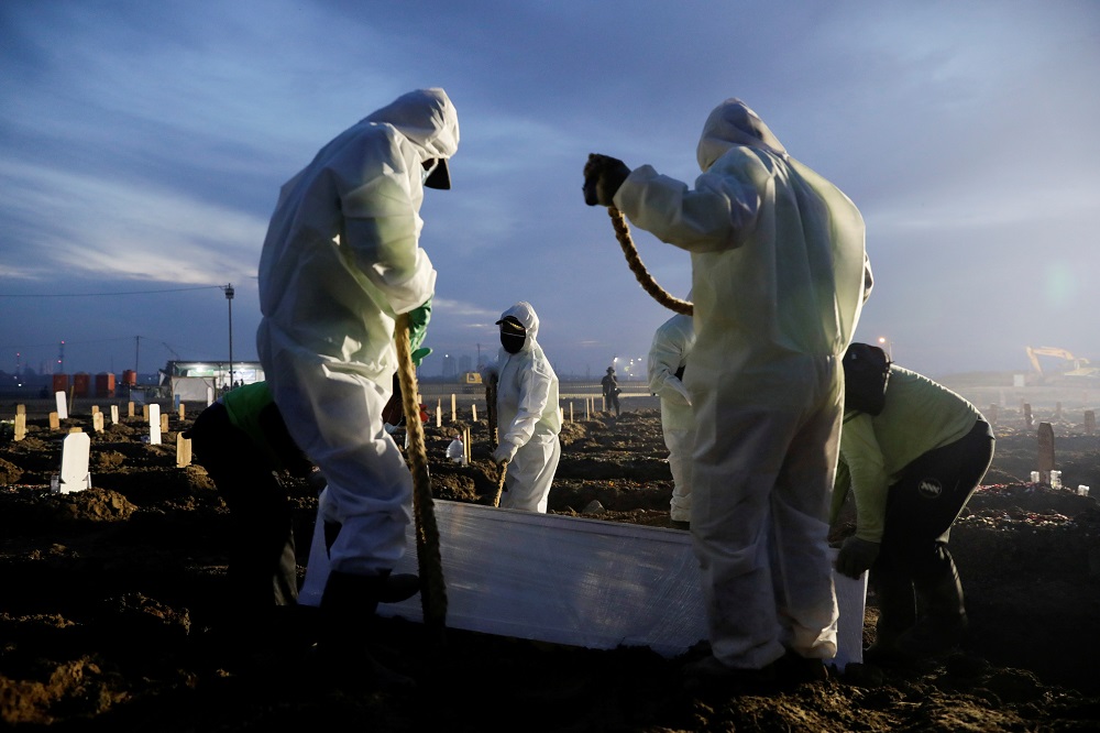 Gravediggers wearing personal protective equipment burry a coffin of a coronavirus disease victim, at the burial area provided by the government for Covid-19 victims, in Jakarta June 28, 2021. u00e2u20acu201d Reuters pic