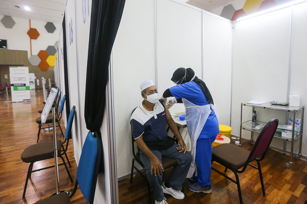 A man receives his Covid-19 vaccine jab at the mega vaccination centre located at UiTM in Puncak Alam June 7, 2021. u00e2u20acu201d Picture by Yusof Mat Isa