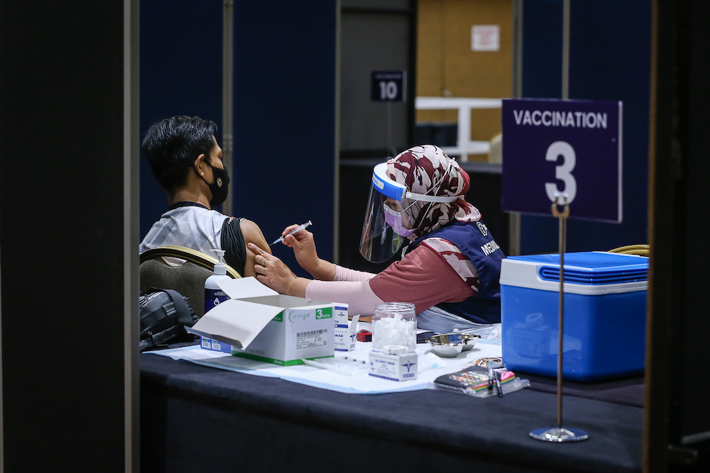 Manufacturing workers in Selangor receive their Pikas Covid-19 jab at the vaccination centre at Setia City Convention Centre in Shah Alam June 28, 2021. u00e2u20acu201d Picture by Yusof Mat Isa