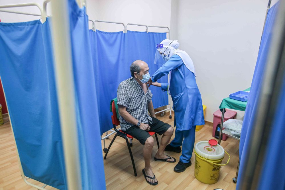 A senior citizen receives a dose of the Sinovac Covid-19 vaccine at the Ar-Ridzuan Medical Centre in Ipoh June 7, 2021. u00e2u20acu201d Picture by Farhan Najib