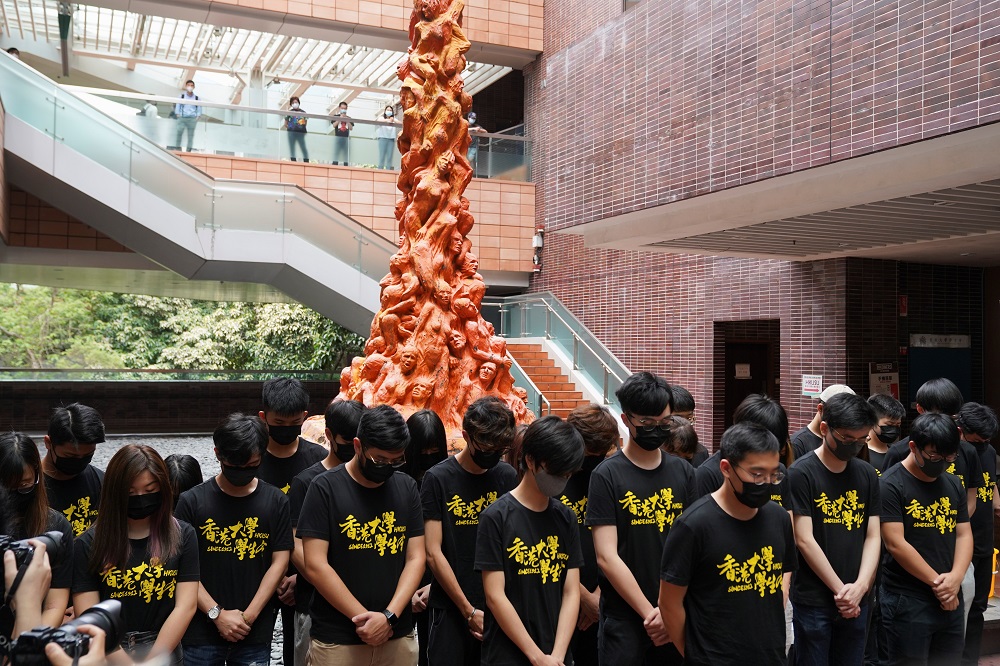 University students observe a minute of silence in front of the u00e2u20acu02dcPillar of Shameu00e2u20acu2122 statue at the University of Hong Kong June 4, 2021. u00e2u20acu2022 Reuters pic