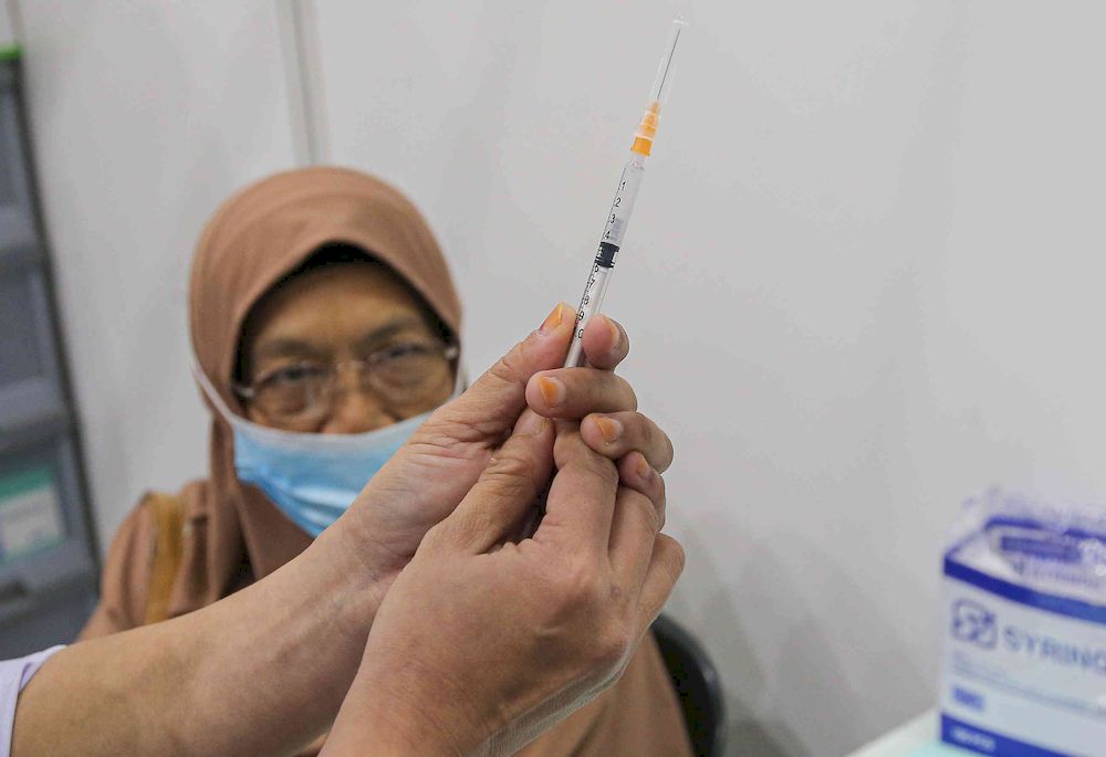 The second phase of vaccination under the National Immunisation Programme going smoothly according to schedule at the vaccination centre (PPV) Stadium Indera Mulia in Ipoh, Perak on June 4, 2021. u00e2u20acu201d Picture by Farhan Najib