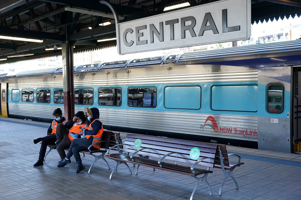 Transport workers sit together on a train platform devoid of passengers at Central Station in Sydney, Australia June 26, 2021. u00e2u20acu2022 Reuters pic