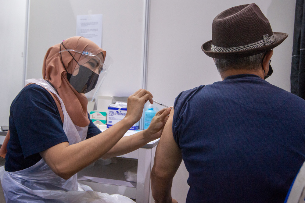People receive their Covid-19 vaccines at the Covid-19 vaccination centre in the Mines International Exhibition and Convention Centre, Seri Kembangan, June 17, 2021. u00e2u20acu201d Picture by Shafwan Zaidon
