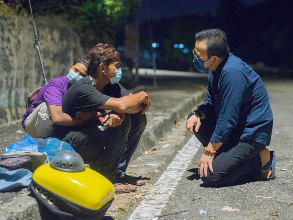 Shah and Siti and their cat were living on the street when Bukit Mertajam MP Steven Sim (right) found out about their situation and helped them. u00e2u20acu201d Picture courtesy of Steven Sim