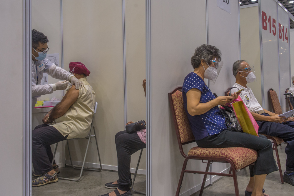 People receive their Covid-19 vaccines during the National Covid-19 Immunisation Programme at Kuala Lumpur Convention Centre in Kuala Lumpur June 8, 2021. u00e2u20acu201d Picture by Shafwan Zaidon