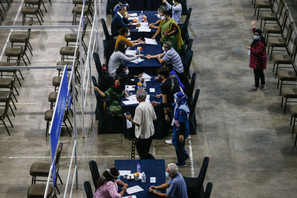 Vaccine recipients register to get their jabs at the vaccine distribution centre, SPICE, June 10, 2021. u00e2u20acu201d Picture by Sayuti Zainudin