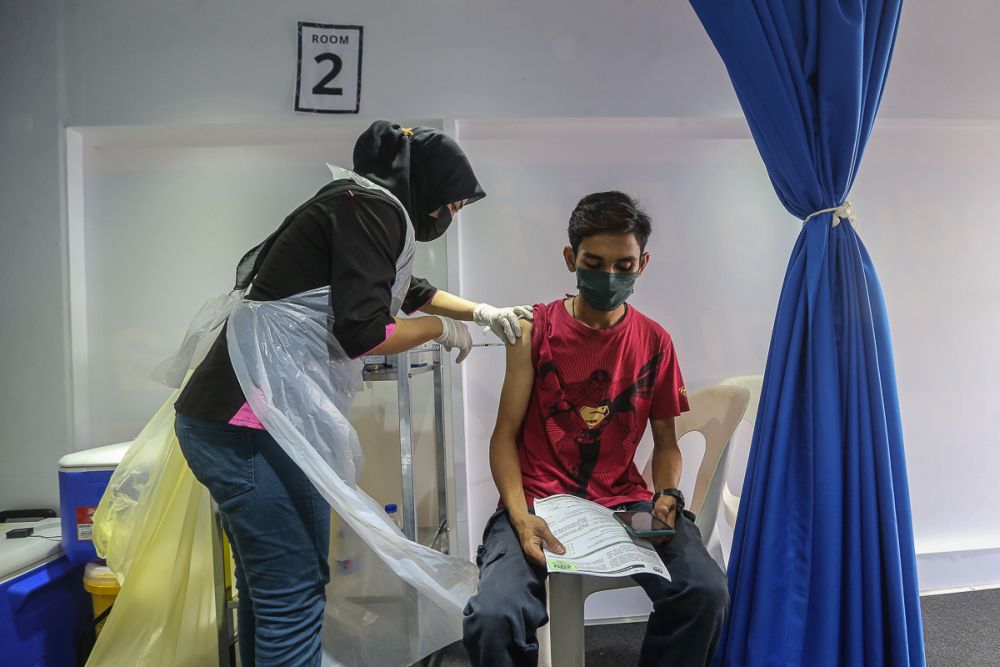 People receive their Covid-19 vaccination through the MYMedic@Wilayah Vaccine Mobile Truck programme at PPR Seri Alam in Kuala Lumpur June 23, 2021. u00e2u20acu201d Picture by Yusof Mat Isa