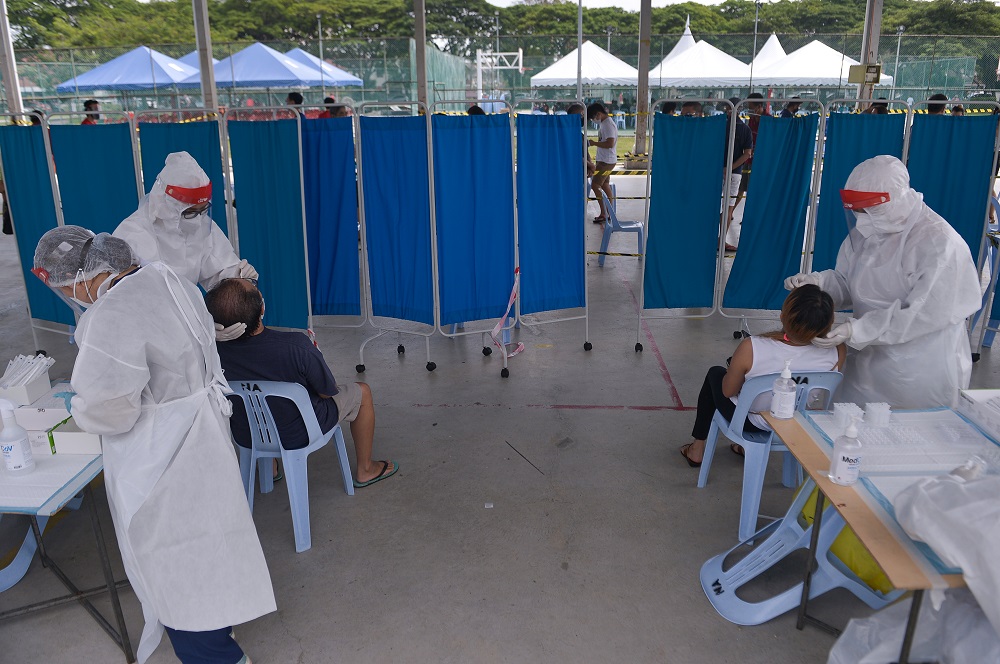 Healthcare workers collect swab samples to test for Covid-19 at the Selcare Clinic in Shah Alam June 24, 2021. u00e2u20acu201d Picture by Miera Zulyana