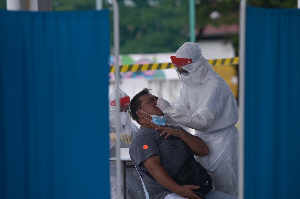 Healthcare workers collect swab samples to test for Covid-19 at the Selcare Clinic in Shah Alam June 24, 2021. u00e2u20acu201d Picture by Miera Zulyana