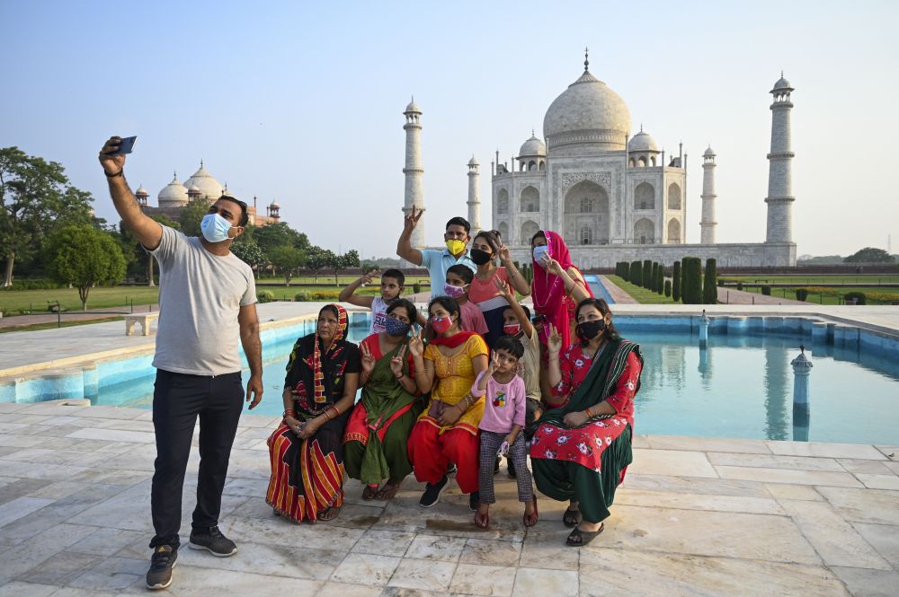 A group of tourists take souvenir photos at the Taj Mahal after it reopened to visitors following authorities easing Covid-19 coronavirus restrictions in Agra on June 16, 2021. u00e2u20acu201d AFP pic