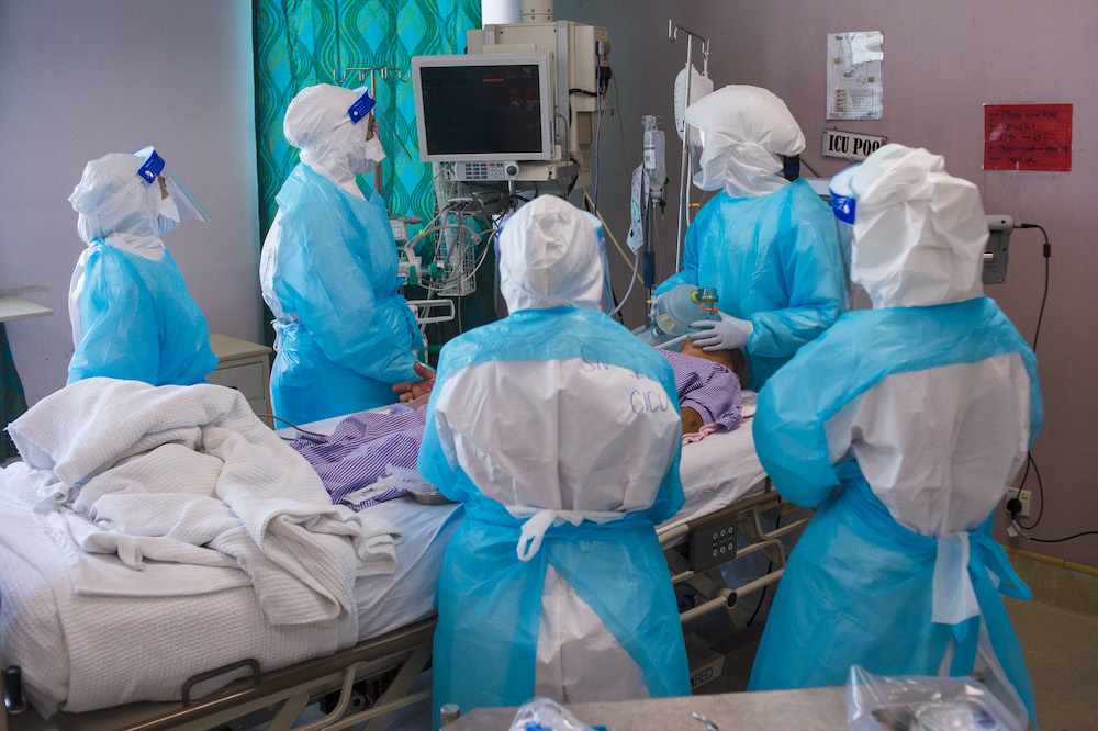 Healthcare workers perform the intubation procedure on a Covid-19 patient in Hospital Serdangu00e2u20acu2122s ICU. u00e2u20acu201d Picture by Shafwan Zaidon