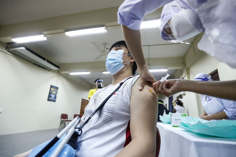 A nurse administers the vaccine to a disabled resident during the vaccination session for Persons with Disabilities in St Nicholas Home, Bagan Jermal July 5, 2021. u00e2u20acu201d Picture by Sayuti Zainudin