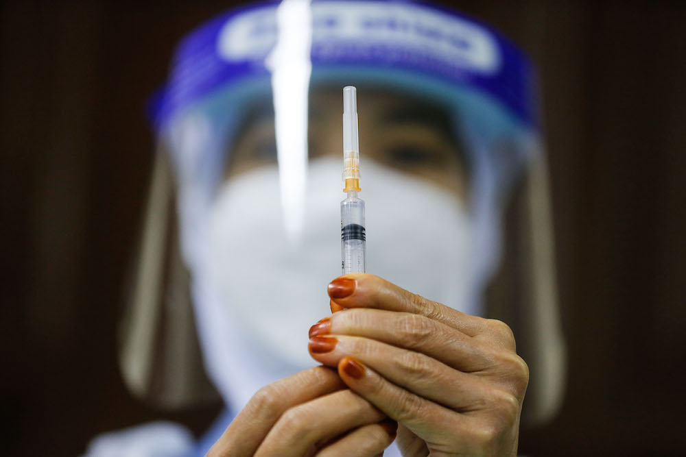 A nurse prepares the vaccine during the vaccination session for Persons with Disabilities in St Nicholas Home, Bagan Jermal July 5, 2021. u00e2u20acu201d Picture by Sayuti Zainudin