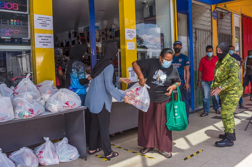 2F Gadget employees and Dana Kita representatives hand over food donations to the needy, at Medan Idaman Business Centre in Kuala Lumpur July 7, 2021. u00e2u20acu201d Picture by Shafwan Zaidon