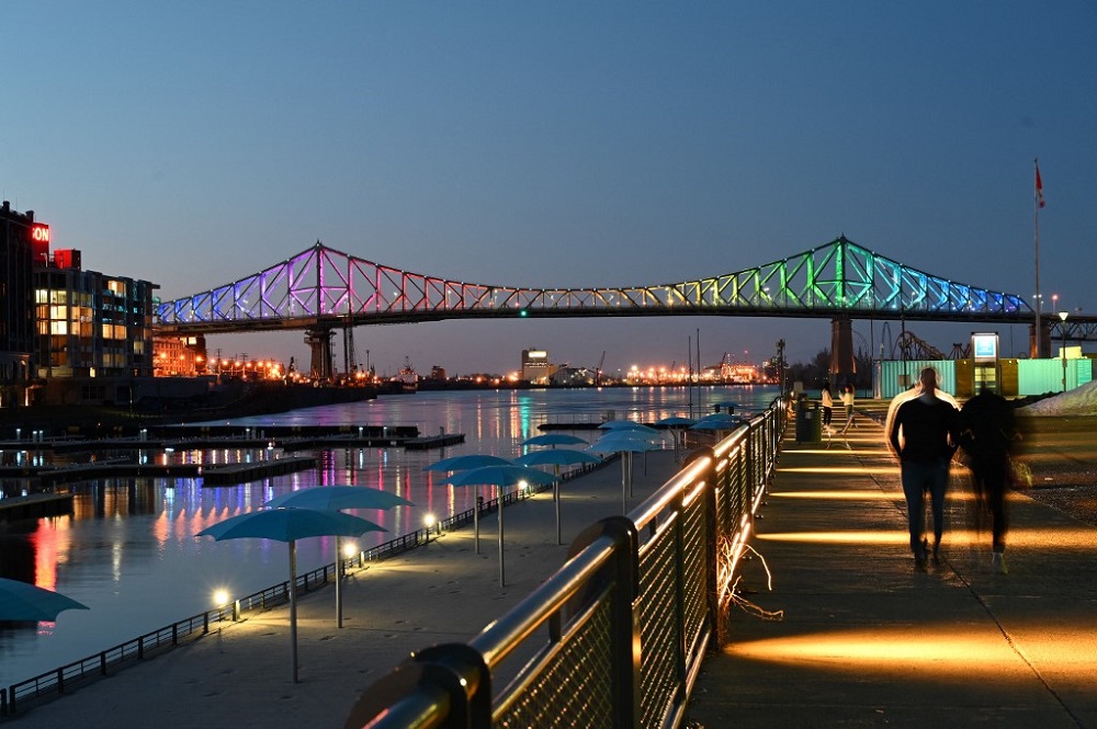 The Jacques-Cartier bridge in Montreal is seen on April 11, 2020, from the tourist district of the Old Port, illuminated in the colours of the rainbow as a sign of hope and in support of victims of the coronavirus. u00e2u20acu201d AFP pic