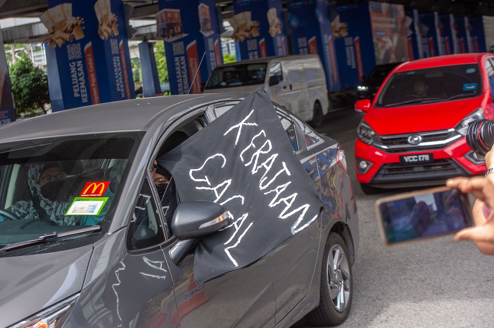 A convoy of cars with black flags are seen around Kuala Lumpur City Centre during a protest July 24, 2021. u00e2u20acu201d Picture by Shafwan Zaidon